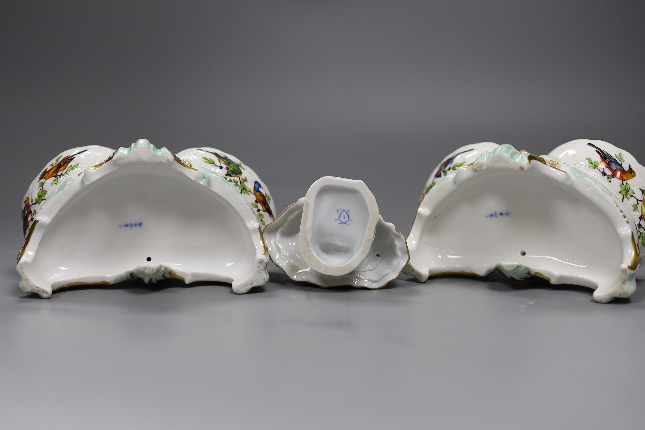 Two Berlin figural salts, 13cm high together with two Dresden saucers and a continental figurine
